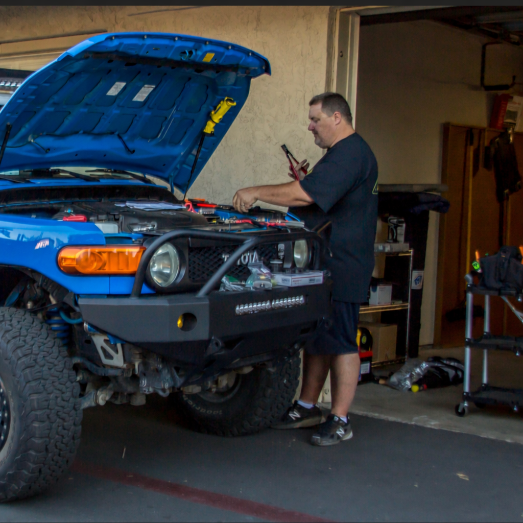 Adventure Wired installer working on a Toyota FJ Cruiser